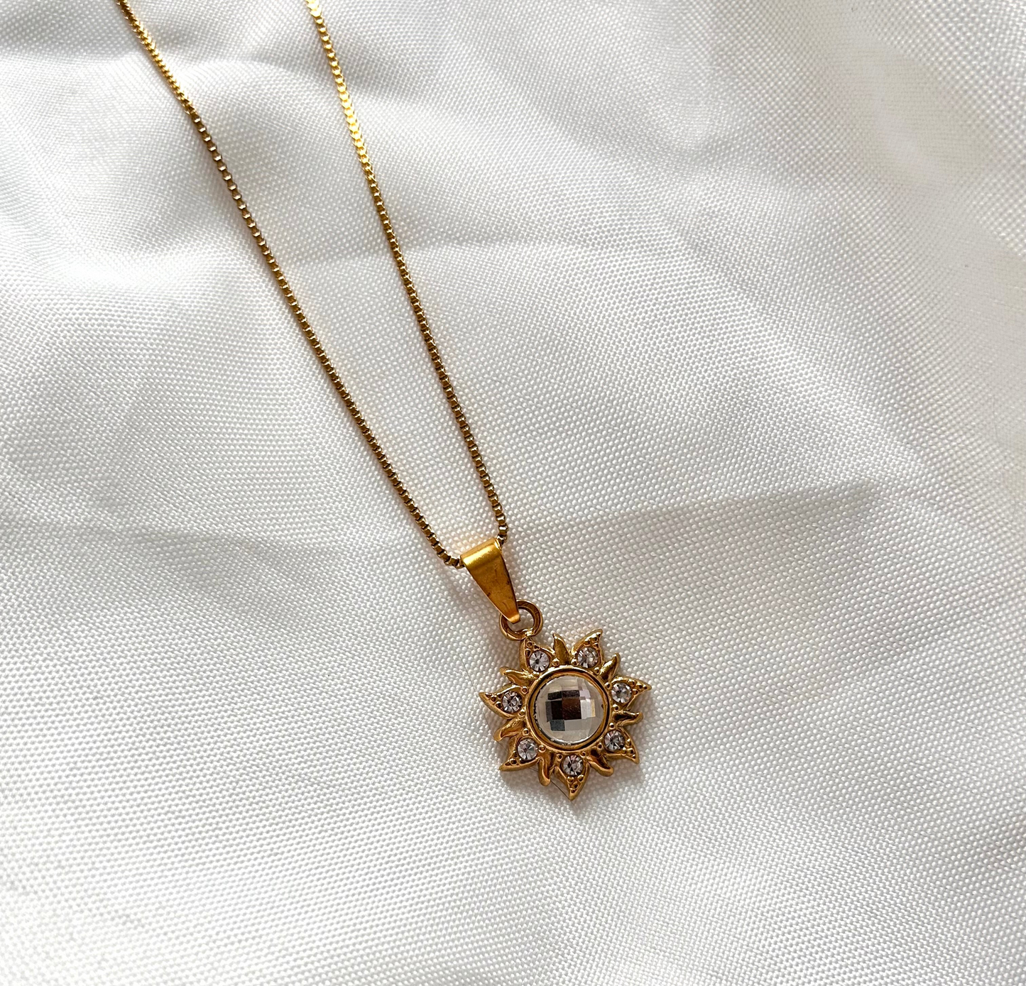 gold necklace with statement sun charm