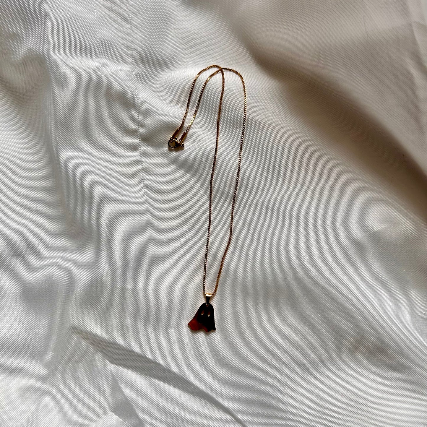 gold necklace with ghost charm