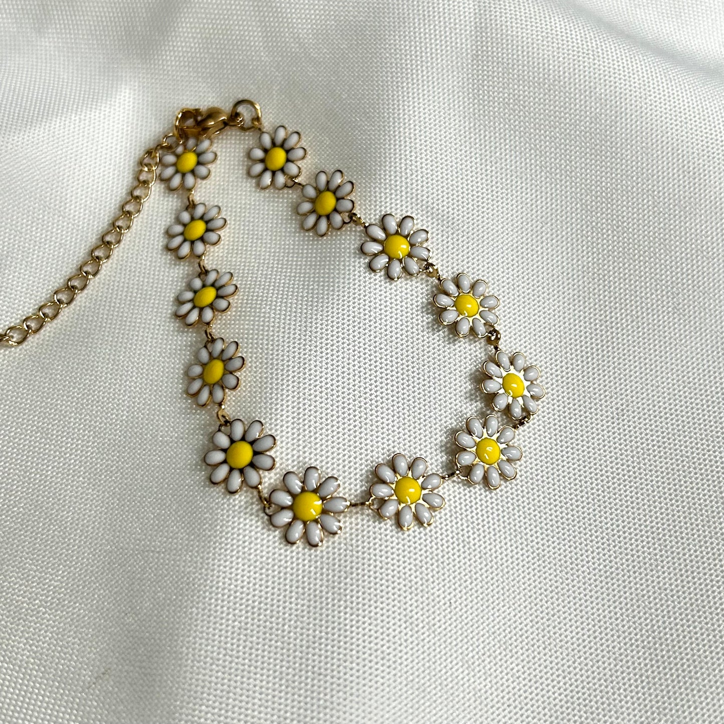 gold bracelet with white daisies
