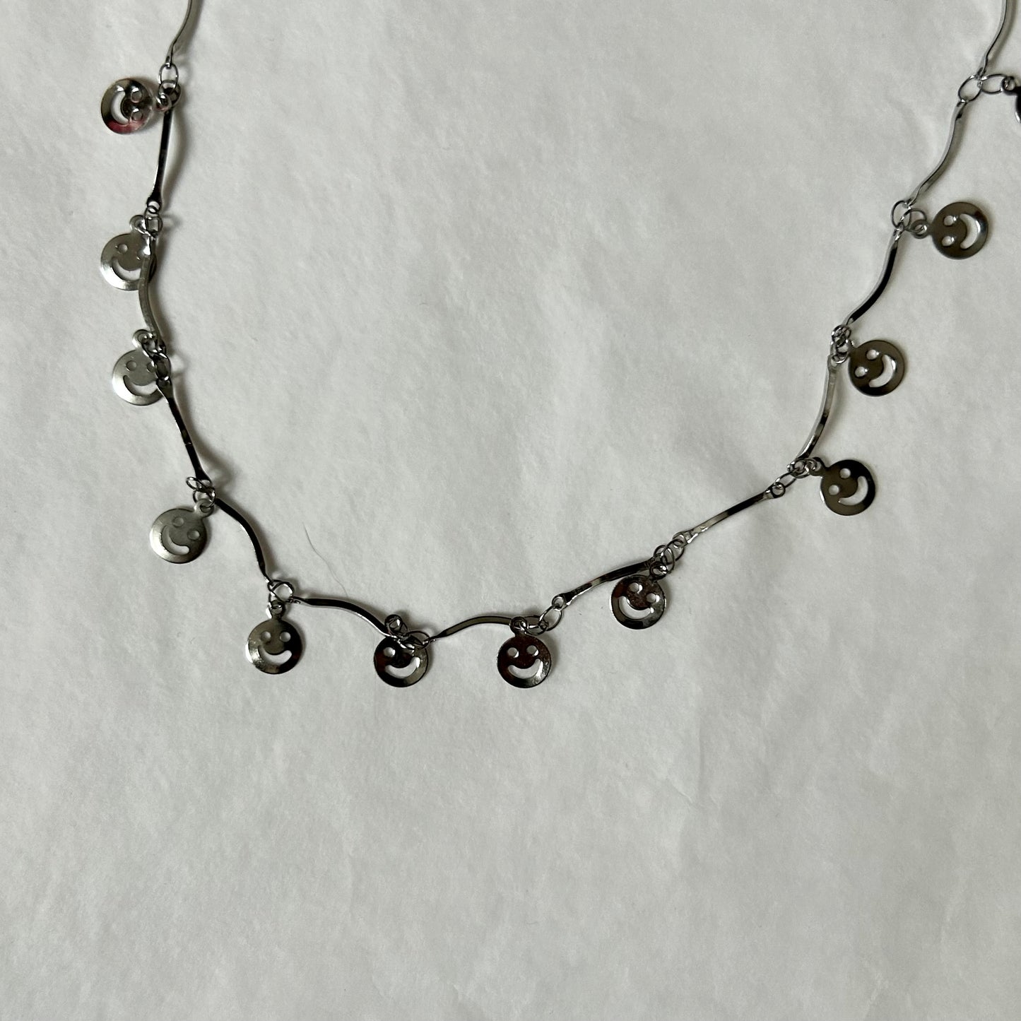 silver necklace with smiley charms