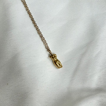 gold necklace with body charm