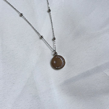 silver necklace with sparkly moon