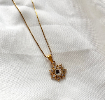 gold necklace with statement sun charm